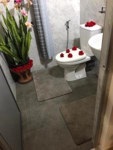 a bathroom with a toilet and a sink with flowers on it at Stanley Villa One in Induruwa +84 photos