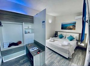 a small bedroom with a bed and a glass table at Stabilimento Lido Burrone in Favignana