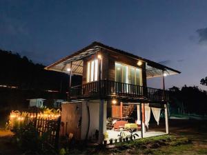 a small house with a balcony on top of it at บ้านนาสลี cottage บ่อเกลือ in Ban Pha Khap