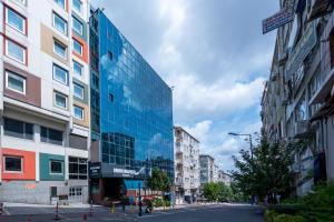 a city street with tall buildings and a blue glass building at Grand Anka Hotel in Istanbul