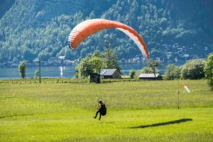 a person in a field with a parachute at Green Lodge in Obertraun