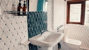 a bathroom with a sink and a toilet at Seashore Mirissa in Mirissa
