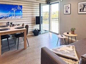 a living room with a table and a couch at 4 person holiday home in GEILO-By Traum in Geilo +20 photos