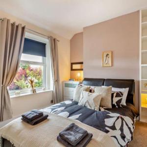 a bedroom with a large bed and a window at Ty Llwyd - Luxury holiday home sleeping 8, Hot Tub available in Llandudno +18 photos