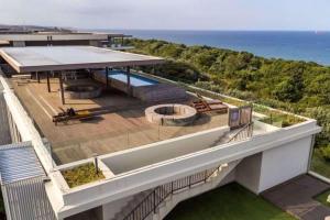 an aerial view of a building with a swimming pool at Luxury Apartment in Pebble Beach Umhlanga in Umhlanga