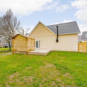 a white house with a large yard in front of it at Cysgod Y Dyffryn - Luxury holiday cottage sleeping 8, Hot Tub available in Pen-y-groes +19 photos