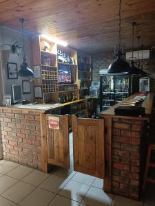 a kitchen with a bar with a brick wall at Chameleon in Kirkwood