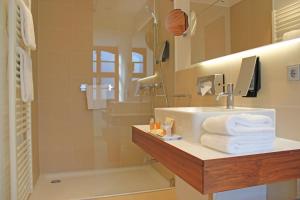 a bathroom with a sink and a shower at Amedia Plaza Dresden in Dresden +35 photos