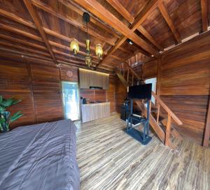 a bedroom with a bed and a piano in a room at Noerbaya House Bukittinggi in Bukittinggi