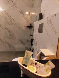 a bathroom with a bowl of toothpaste and a toilet at Villa Forever Coorg in Madikeri
