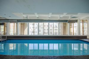 a swimming pool in a building with a large window at #1905 Cartwright - The Spitfire in Cape Town