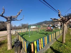 a park with a playground with trees and a fence at Loft Surf & Music in Gandara