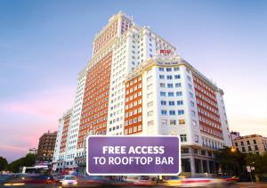 a large building with a free access to roof top bar at Riu Plaza España in Madrid