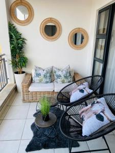 a living room with two tables and a couch at Luxury beach lagoon 1 Bedroom apartment in Pretoria