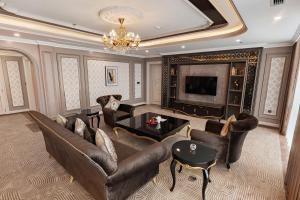 a living room with leather furniture and a television at Muong Thanh Luxury Cao Bang in Cao Bằng