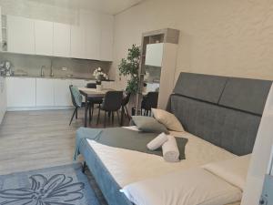 a kitchen and a living room with two beds in a room at B&B Luxury House Rho in Rho