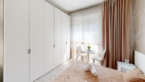 a bedroom with a bed and a table and chairs at B&B Luxury House Rho in Rho