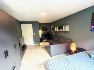 a living room with a bed and a couch at House close to World cup Trondheim 2025 in Trondheim