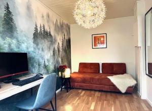 a bedroom with a bed and a desk with a computer at House close to World cup Trondheim 2025 in Trondheim
