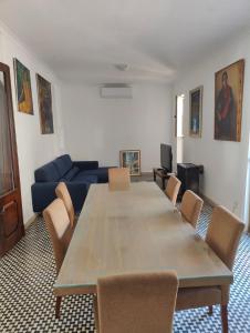 a living room with a large wooden table and chairs at Location, Location, Location in St. Julianʼs