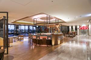 a lobby with a bar and some tables and chairs at Cuncyue Hot Spring Resort in Luodong