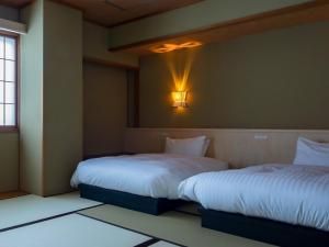 Postel nebo postele na pokoji v ubytování Gion Ryokan Karaku