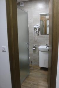 a bathroom with a shower with a sink and a mirror at Planinska Kraljica in Gornje Pale +123 photos