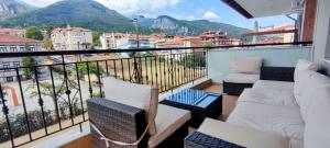 a balcony with couches and a view of mountains at Olympus Panorama Luxury Apartment in Litochoro
