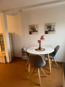 HeeßenにあるFerienwohnung Schwalbennest in Heeßenの白いテーブルと椅子のあるダイニングルーム +11枚の写真