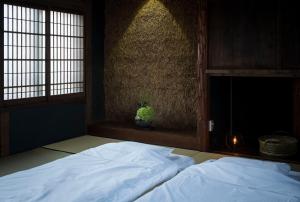 Postel nebo postele na pokoji v ubytování アイショウ 一日ひと組の宿
