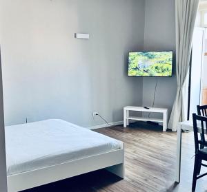 a bedroom with a bed and a flat screen tv at Best Stay - Central Station Suite Apartments in Bari