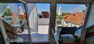 an open balcony with a view of a building at coLodging Mannheim - private rooms & kitchen in Mannheim +11 photos