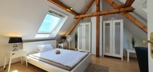 a bedroom with a white bed and a window at coLodging Mannheim - private rooms & kitchen in Mannheim
