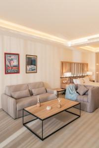 a living room with two couches and a table at Hotel Saint Georges Beirut in Al Marfaʼ