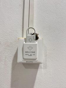 a white padlock is hanging on a wall at สบายดีห้องเช่า รายวัน รายเดือน in Sa Kaeo