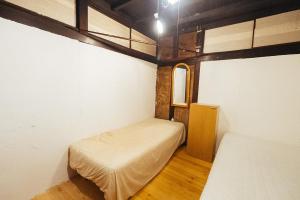 Postel nebo postele na pokoji v ubytování hinatabocco guesthouse