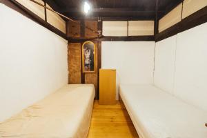 Postel nebo postele na pokoji v ubytování hinatabocco guesthouse