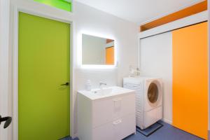a bathroom with a green door and a washing machine at HOKKAIDO VILLA e2 in Nakafurano +37 photos