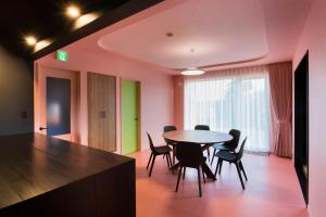 a dining room with a table and chairs at HOKKAIDO VILLA e2 in Nakafurano