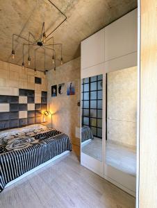 a bedroom with a large bed and a walk in closet at Apartment in bagebi in Tbilisi City
