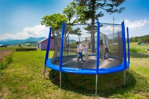a group of people playing on a trampoline at HOKKAIDO VILLA e2 in Nakafurano