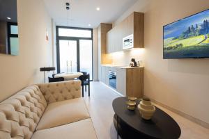a living room with a couch and a table at FLORIT FLATS - The Benicalap Residences in Valencia