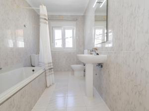 a white bathroom with a sink and a tub and a toilet at Cubo's Casa Camino del Cantinero in Ardales +38 photos