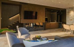 a living room with a couch and chairs and a bar at Villa Volpe Verde in Buje