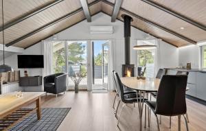 a kitchen and dining room with a table and chairs at Amazing Home In Hvide Sande With Wifi in Bjerregård
