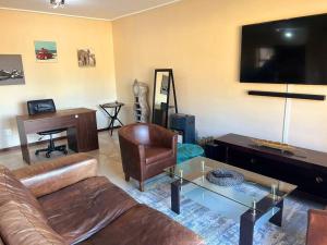a living room with a couch and a table at Elegant Estates in Roodepoort