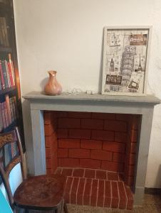 a brick fireplace with a vase sitting on top of it at La Vista Sul Castello in Compiano