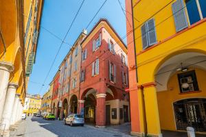 a group of buildings on a city street at Casa delle Note in Modena +29 photos
