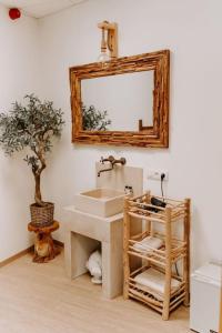 a bathroom with a sink and a mirror on the wall at Suite de charme avec jacuzzi et cabine infrarouge in Tubize