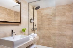 a bathroom with a sink and a mirror at NH Collection Madrid Palacio de Tepa in Madrid